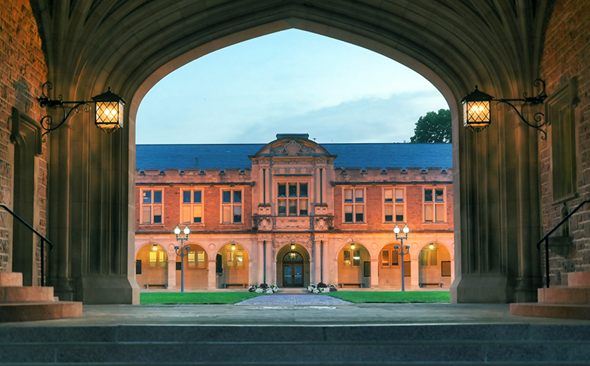 Photo of Ridgely Hall at sunset, through arches
