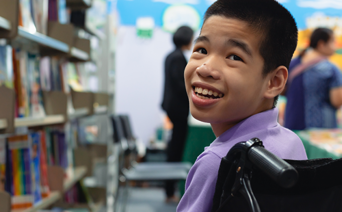 Young boy with special needs at a book fair
