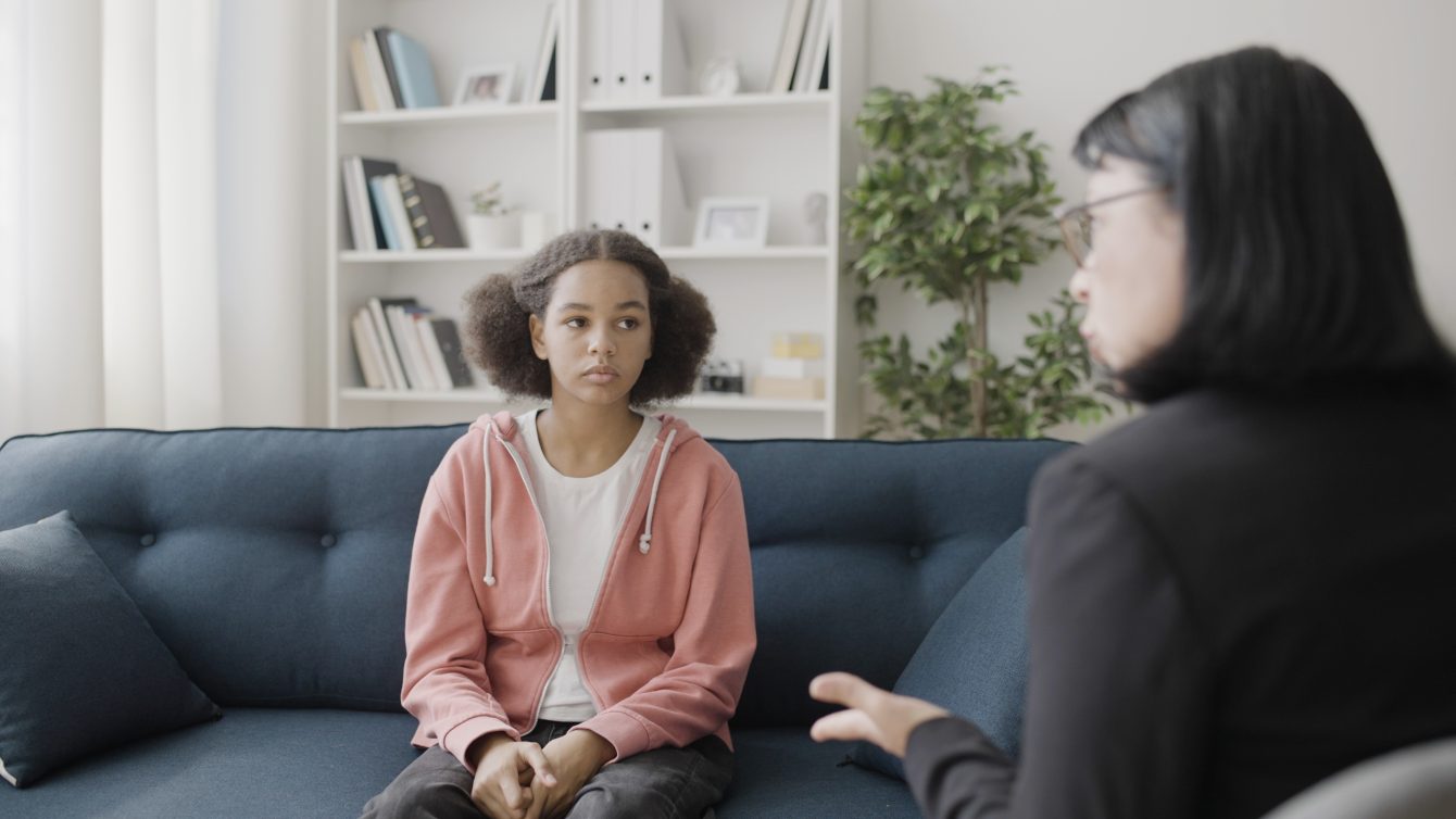 Therapist talking to a child.