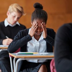 Teen at school desk with anxiety